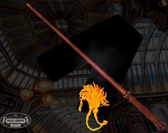 May include: A brown wooden wand with a gold tassel, lying on a black velvet pouch. The wand is about 14 inches long.