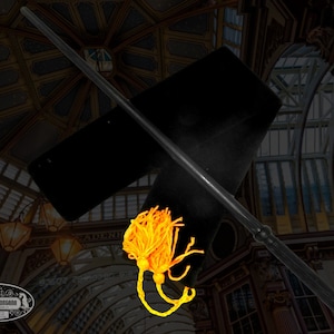 May include: A black wooden wand with a gold tassel. The wand is lying on a black velvet cloth. The background is a dark, ornate ceiling.
