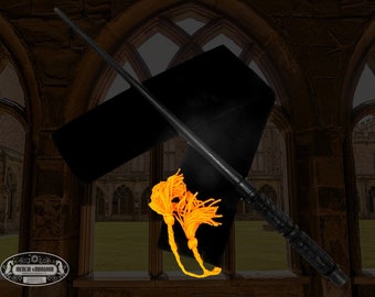 May include: A black wooden wand with a gold tassel, resting on a black velvet pouch. The wand is displayed against a backdrop of a stone archway.