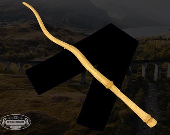 May include: A wooden wand with a curved handle and a pointed tip. The wand is light brown in color and is resting on a black velvet background.