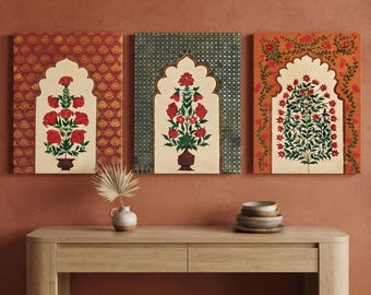 May include: Three rectangular wall art prints featuring central arched niches containing botanical illustrations of red flowers in vases. The left print has a red patterned background, the center has a green grid, and the right has orange floral vines.