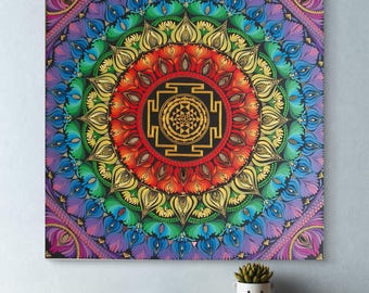 May include: A square wall art piece featuring a vibrant, multi-colored mandala design. The center displays a golden Sri Yantra symbol surrounded by concentric rings of red, orange, yellow, green, blue, and purple petal-like patterns.