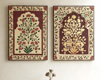 May include: Two rectangular wall art pieces featuring a central archway design with floral motifs. The left piece displays red and green flowers on a cream background, while the right piece features gold floral patterns on a deep maroon background.