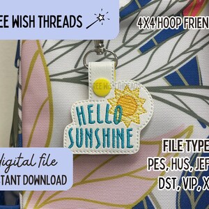 May include: A white embroidery design with a yellow sun and the text "HELLO SUNSHINE" in blue. The design is on a white background with a pink and yellow floral pattern. The design is 4x4 hoop friendly and includes the following file types: PES, HUS, JEF, EXP, DST, VIP, XXX.