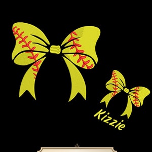 May include: Two yellow softball-themed bows with red stitching. The larger bow is on the left and the smaller bow is on the right. The text "Kizzie" is below the smaller bow. The text "5 SIZES" is in a brown rectangle at the bottom of the image.