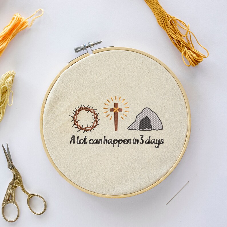 May include: Embroidered hoop art with a crown of thorns, a cross, and a tomb. The text reads "A lot can happen in 3 days".