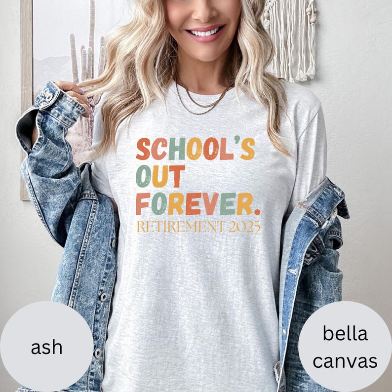 May include: Ash-colored long-sleeve t-shirt with the text "SCHOOL'S OUT FOREVER. RETIREMENT 2025" in orange, green, and yellow. The shirt is made of Bella Canvas material.