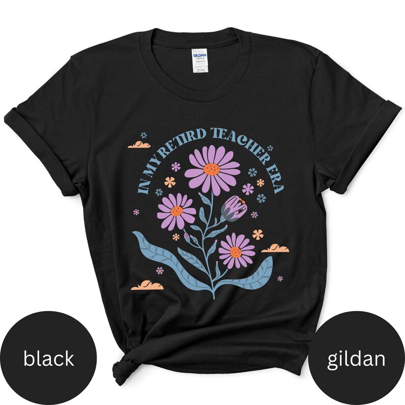 May include: Black t-shirt with a floral design and the text "In My Retired Teacher Era".
