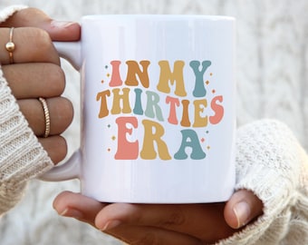 May include: White ceramic mug with a colorful graphic that says "In My Thirties Era".