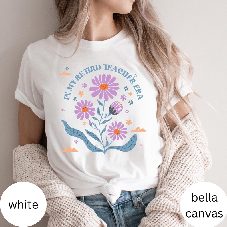 May include: White t-shirt with a floral design and the text "In My Retired Teacher Era".