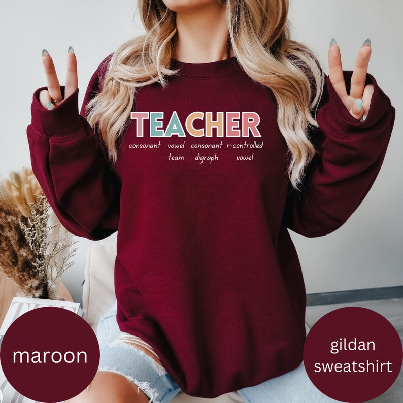 May include: Maroon Gildan sweatshirt with the word "TEACHER" spelled out in colorful letters. The letters are defined as "consonant, vowel, consonant, r-controlled, team digraph, vowel".