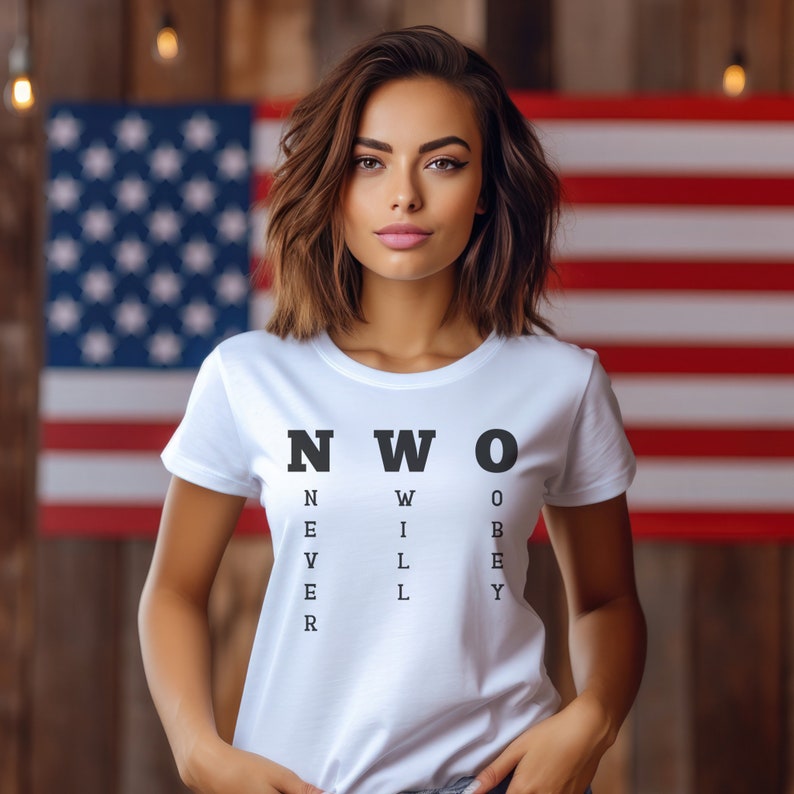 May include: White t-shirt with the text "NWO" in black letters. The letters are stacked vertically with the words "NEVER" and "WILL" and "OBEY" written underneath.