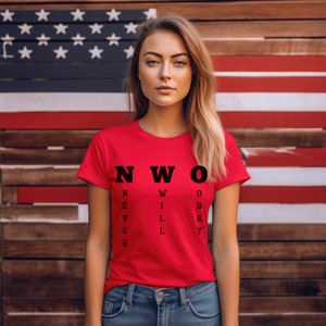 May include: A red t-shirt with a black eye chart design that reads "NWO" with the letters spelling out "Never Will Obey".