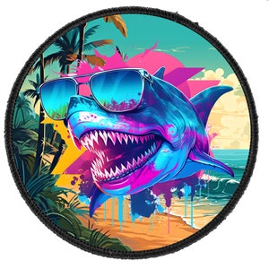 May include: A colorful illustration of a shark wearing sunglasses on a beach with palm trees. The shark is blue, pink, and yellow with a bright white smile. The background is a sunset with a blue ocean.