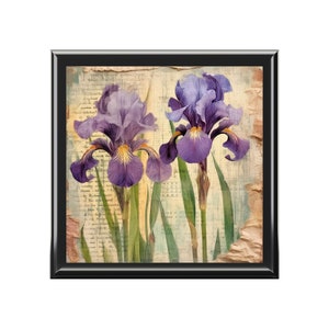 May include: Two purple iris flowers with yellow centers are depicted on a vintage sheet music background. The flowers are in focus, while the background is blurred.