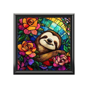 May include: A stained glass style illustration of a sloth with a happy expression surrounded by colorful flowers. The sloth is brown with a light brown belly and is positioned in the center of the image. The flowers are a variety of colors including red, orange, yellow, pink, and purple.