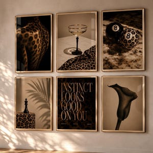 May include: A gallery wall set of six framed prints featuring a leopard print back, a cocktail glass, two eight balls, a chess piece on a leopard print base, text reading INSTINCT LOOKS GOOD ON YOU, and a single calla lily in sepia tones.