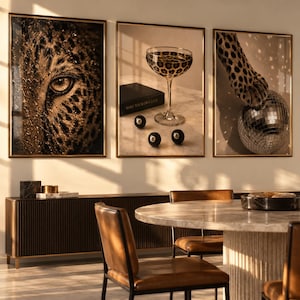 May include: A triptych of framed wall art featuring a close-up of a leopard eye, a cocktail glass with a leopard print pattern next to three black eight balls and a box labelled MAKE YOUR OWN LUCK, and a leopard paw resting on a disco ball.