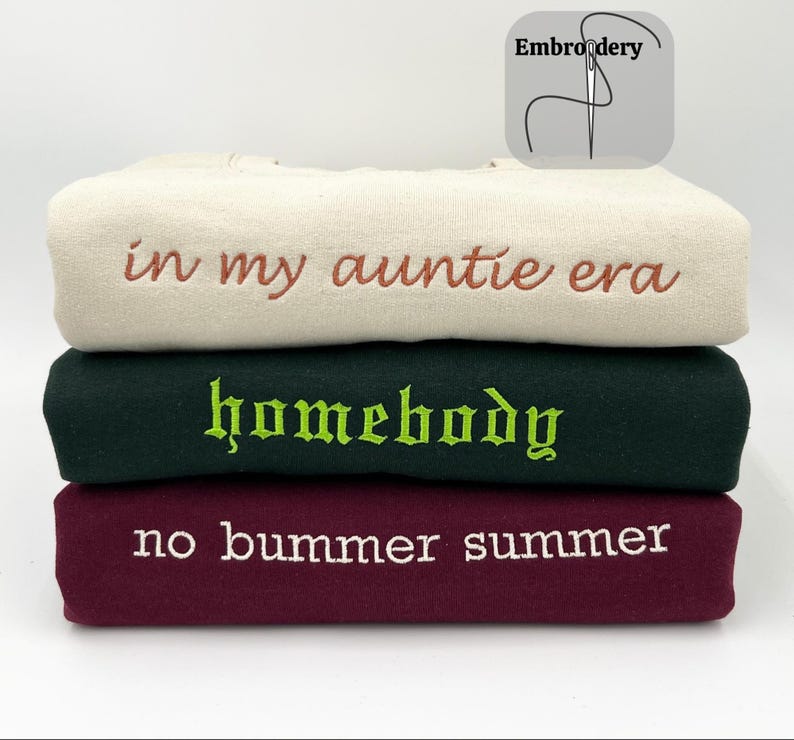 Custom embroidered Gildan 18000 sweatshirts in sand, forest green and maroon sweatshirts. Font #19, Font #21 and Font #26 are used for sand (on the top), forest green (in the middle) and maroon (at the bottom). Thread colors are clay brown, lime green and white, respectively.
