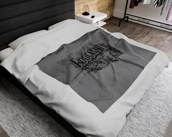 May include: Gray and white bedding with a gray throw blanket featuring the word "Rockland" in black lettering.