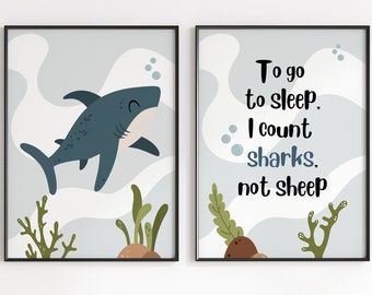 May include: Two framed prints with a blue shark and the text "To go to sleep, I count sharks, not sheep". The prints are hanging on a white wall above a black and white striped teepee tent.