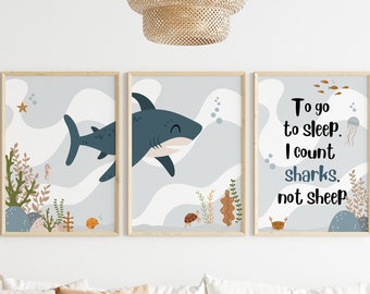 May include: Three framed prints with a blue shark, ocean waves, and coral reef designs. The text on the right print reads "To go to sleep, I count sharks, not sheep."