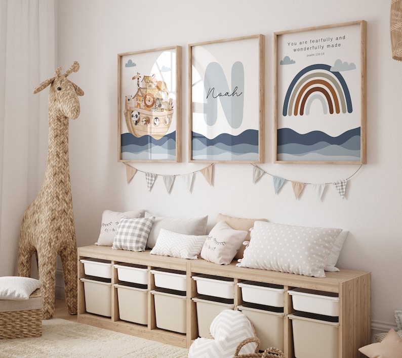 May include: Three framed prints with a nautical theme. The first print features a cartoon illustration of Noah's Ark with animals on board. The second print features the name Noah in a blue and white font. The third print features a rainbow with the text "You are fearfully and wonderfully made" and a scripture reference.