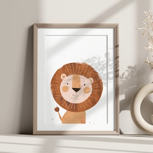May include: A framed print of a cartoon lion with a brown mane and a pink nose. The lion is smiling and has a friendly expression. The print is on a white background and is framed in a light brown frame.