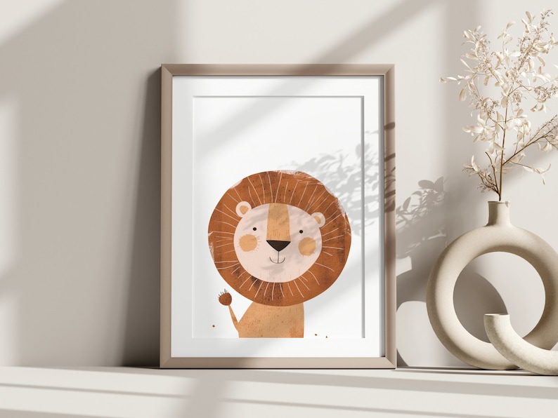 May include: A framed print of a cartoon lion with a brown mane and a pink nose. The lion is smiling and has a friendly expression. The print is on a white background and is framed in a light brown frame.