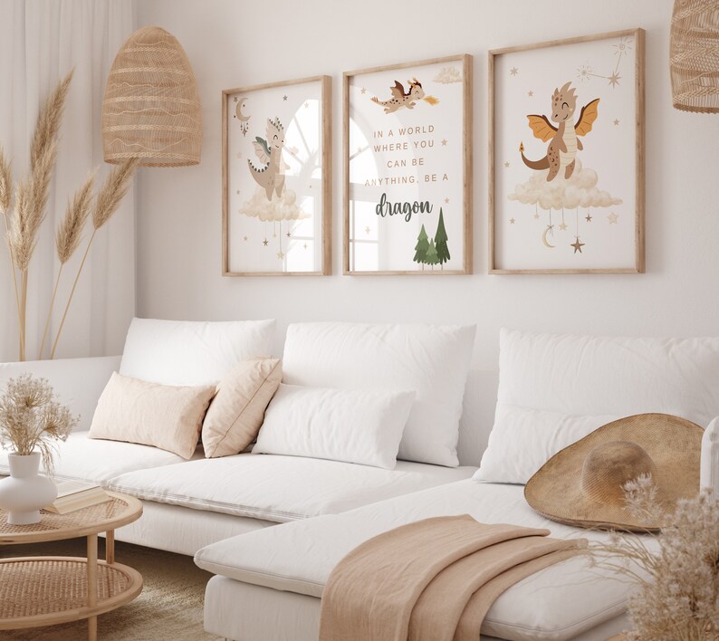 May include: Three framed prints with illustrations of dragons and stars. The middle print has the text "In a world where you can be anything, be a dragon."