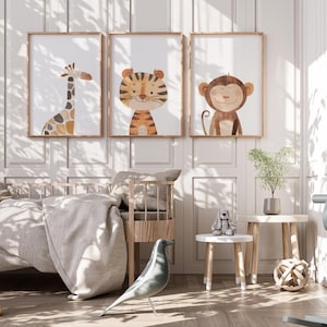May include: Three watercolour animal illustrations in frames on a white wall. The illustrations are of a giraffe, a tiger, and a monkey. The frames are brown wood and the illustrations are on white paper.