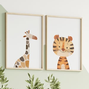 May include: Two framed prints featuring illustrations of a giraffe and a tiger. The giraffe is brown and orange with a long neck and spots. The tiger is orange and black with stripes. Both animals are smiling.