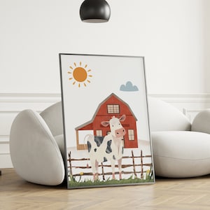May include: A framed illustration of a white and black cow standing in front of a red barn with a yellow sun and a blue cloud in the background.