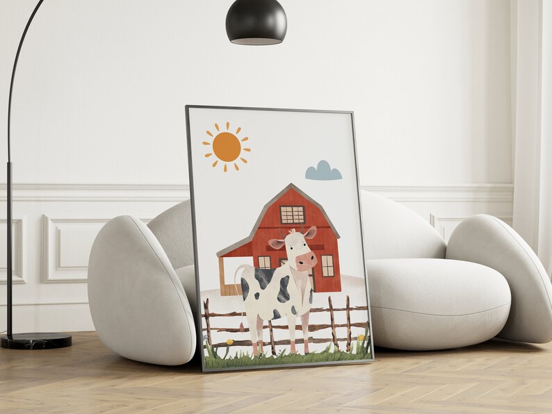 May include: A framed illustration of a white and black cow standing in front of a red barn with a yellow sun and a blue cloud in the background.