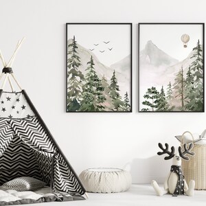 May include: Two framed watercolour paintings of a mountain landscape with trees and a hot air balloon. The paintings are hung on a white wall above a black and white striped teepee tent.