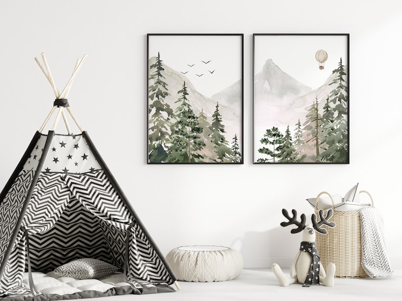 May include: Two framed watercolour paintings of a mountain landscape with trees and a hot air balloon. The paintings are hung on a white wall above a black and white striped teepee tent.