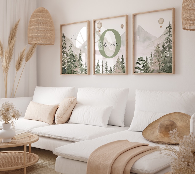 May include: Three framed watercolour prints depicting a mountain and forest scene. The central print features a large green letter "O" with the name "Oliver" written in cursive. The prints have a rustic, boho aesthetic.