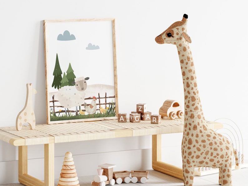 May include: A framed illustration of a white sheep, a brown hen, and yellow chicks in a green field with trees and a wooden fence. The illustration is hanging on a white wall above a wooden bench with a stuffed giraffe, wooden blocks, and a wooden toy train.