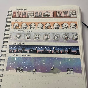 May include: A notebook with five different washi tapes. The tapes feature illustrations of books, shelves, food, polaroids, and a cityscape. The text on the tapes reads "Planner", "Dinner", "Polaroid Love", "Cityscape", and "Winter Aurora".
