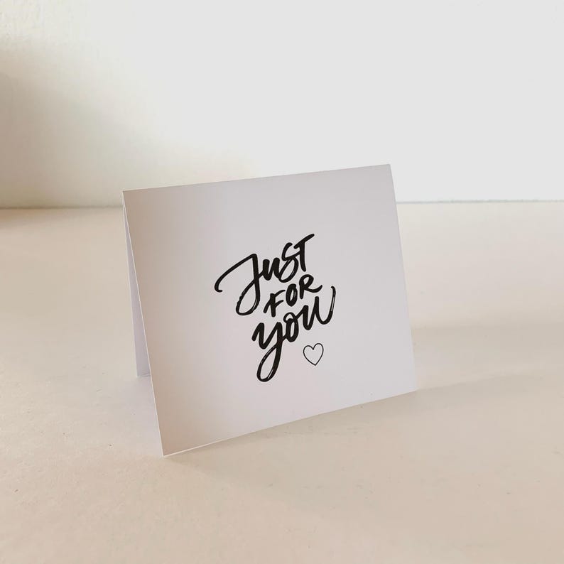 May include: A white ceramic mug with a black handle and the text "But First, Coffee" in a black, bold font. The mug is likely 11-15 ounces and is suitable for hot beverages.