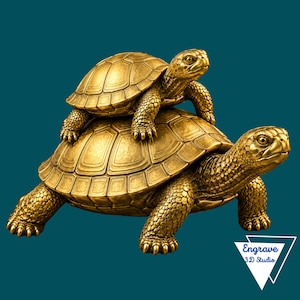 May include: A gold-colored sculpture of two turtles, with a smaller turtle positioned on top of a larger turtle. Both turtles feature detailed shell patterns and textured skin. A white triangular logo with the text Engrave 3D Studio is visible.
