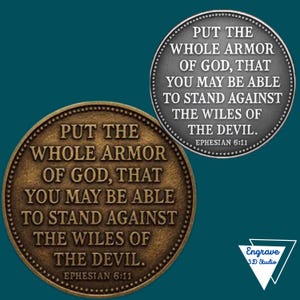 May include: Two round, bronze-colored coins with the text "PUT THE WHOLE ARMOR OF GOD, THAT YOU MAY BE ABLE TO STAND AGAINST THE WILES OF THE DEVIL. EPHESIAN 6:11." One coin is bronze, the other is gray.
