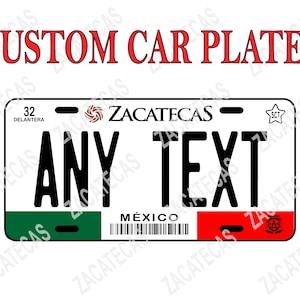 May include: A white license plate with green, red, and white stripes at the bottom. The plate has black text that reads "32 DELANTERA ZACATECAS - ANY TEXT - SCT MEXICO".
