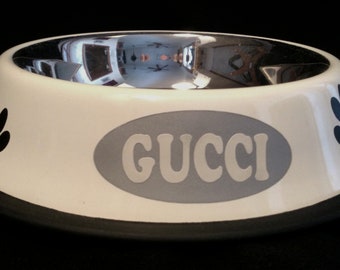 Personalized white bowl decorated with Bones and/or Non-slip paw with the name of your animal.