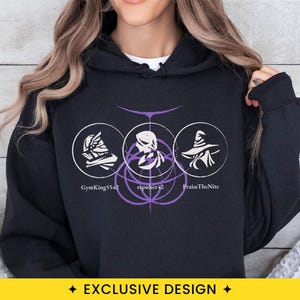 May include: A black hooded sweatshirt featuring a graphic print with three white circular icons containing a helmet, a profile silhouette, and a pointed hat. Below the icons, the text reads GymKing5542, repulser42, and PraiseTheNite.