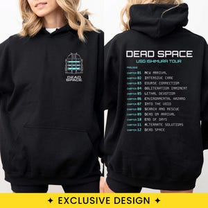 May include: A black hooded sweatshirt featuring a small Dead Space logo on the front. The back displays the text Dead Space USG Ishimura Tour followed by a list of chapters from 01 to 12 with their respective titles in light blue and white text.