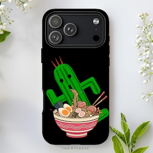 May include: Black phone case featuring a green cactus character with orange spikes, holding a bowl of ramen with chopsticks. The bowl has a red and white striped design. The text "TSHIRTCACHE" is at the bottom.