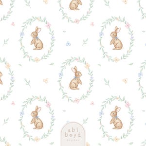 May include: A repeating pattern of watercolor bunnies, each within a floral wreath. The bunnies are light brown with blue ribbons. The wreaths feature pastel flowers and green leaves on a white background. The text "abi boyd DESIGNS" is at the bottom.