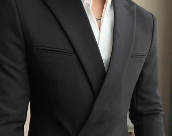 Puede incluir: Una chaqueta de traje negra con un cierre de botón único y una solapa puntiaguda. La chaqueta tiene un corte ajustado y un diseño moderno.