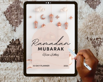 May include: A digital tablet displaying a 30-day planner for Ramadan Mubarak. The planner features a pink background with gold lanterns and clouds. The text "Ramadan Mubarak" is written in black with Arabic text below. The year 2024 is displayed in the bottom right corner.